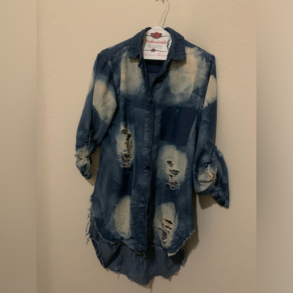 Women’s blue jeans ripped blouse.
